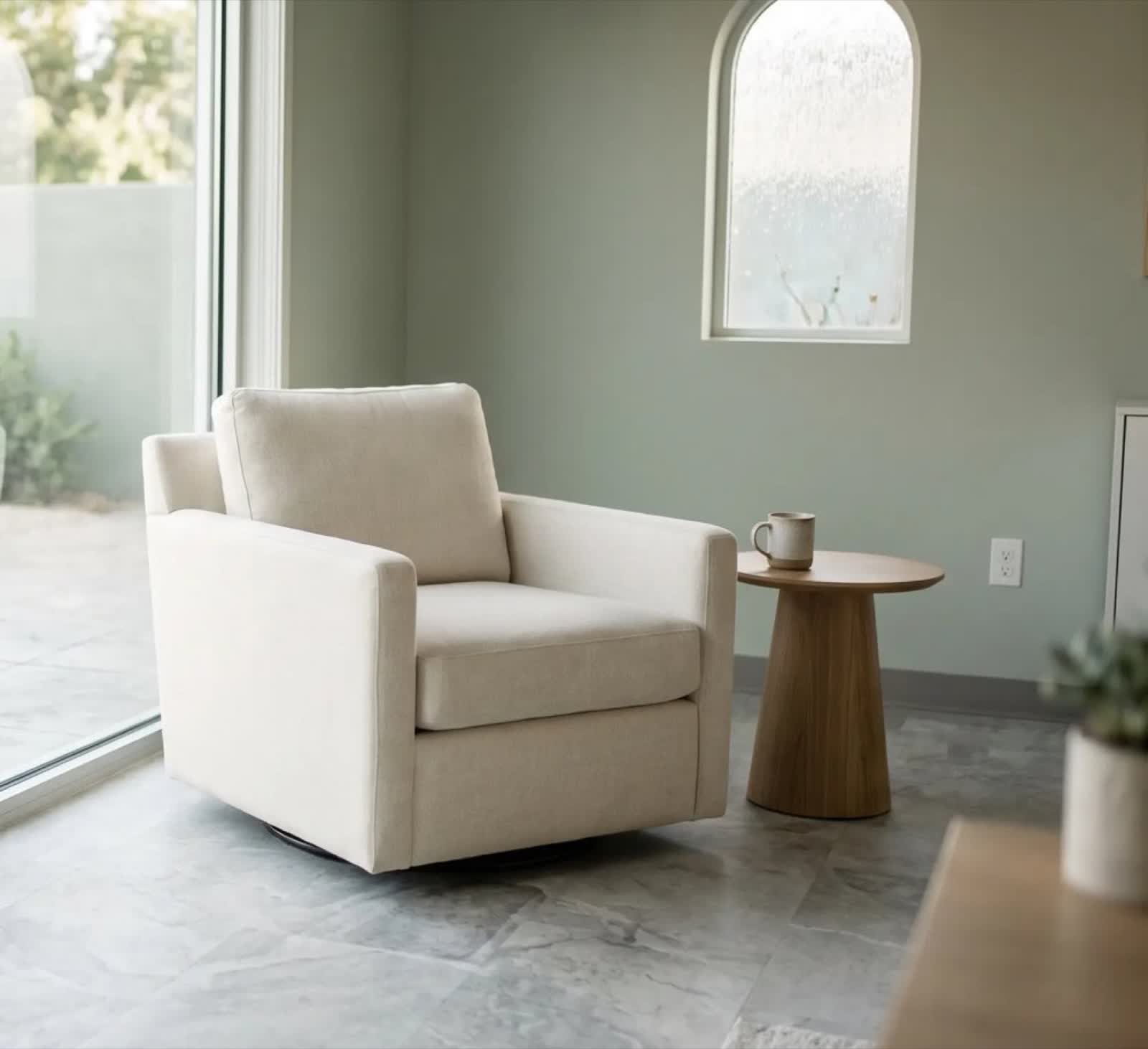 A calm armchair beside soft natural light, the kind of quiet setting this work happens in